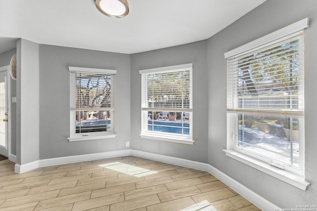 interior space with wood tiled floor and baseboards