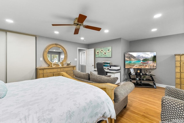 bedroom featuring baseboards, ceiling fan, light wood-style flooring, and recessed lighting