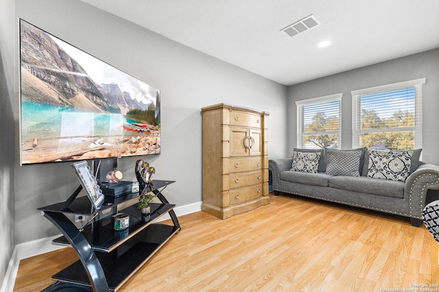 office area featuring baseboards, visible vents, and wood finished floors