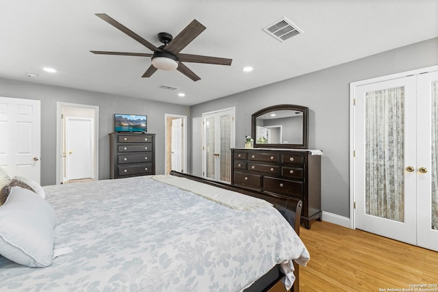 bedroom featuring french doors, wood finished floors, visible vents, and recessed lighting