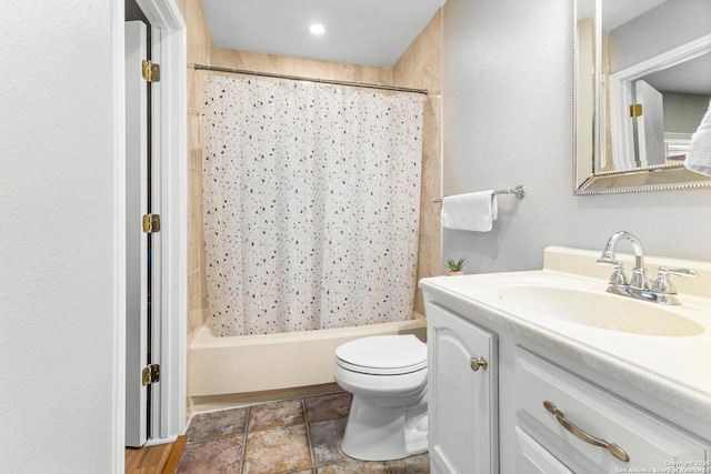 full bathroom featuring shower / bath combination with curtain, vanity, and toilet