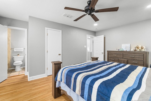 bedroom with ensuite bathroom, ceiling fan, visible vents, baseboards, and light wood finished floors