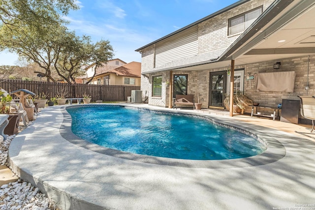 view of swimming pool featuring a patio area, a fenced backyard, central AC, and a fenced in pool