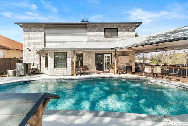 view of swimming pool with a fenced in pool, fence, a patio, and central air condition unit