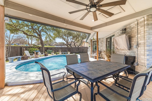 view of patio / terrace featuring ceiling fan, outdoor dining area, a fenced backyard, and a fenced in pool