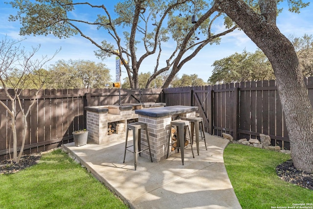 view of patio / terrace with a fenced backyard and outdoor dry bar