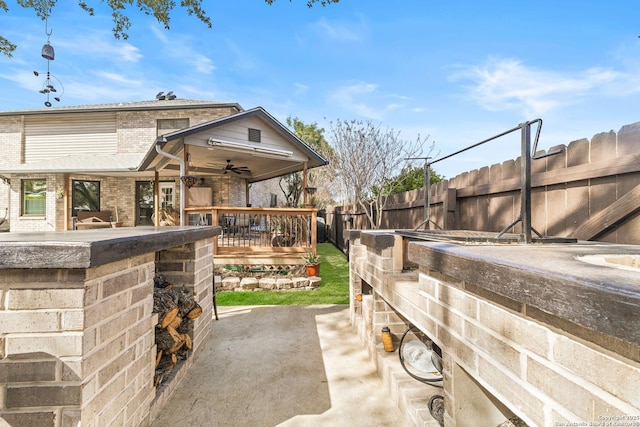 view of patio featuring a fenced backyard and a ceiling fan