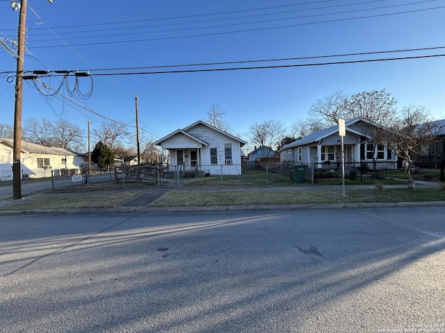 bungalow-style home featuring a fenced front yard