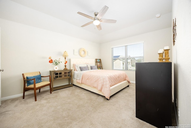 bedroom with baseboards, a ceiling fan, and light colored carpet