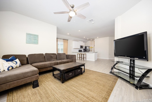 living area with recessed lighting, visible vents, light wood-style floors, ceiling fan, and baseboards