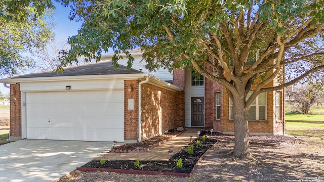 view of front facade with driveway, an attached garage, and brick siding