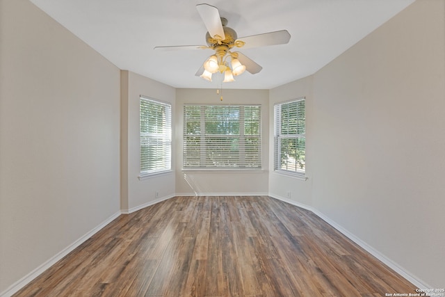 unfurnished room with ceiling fan, baseboards, and wood finished floors