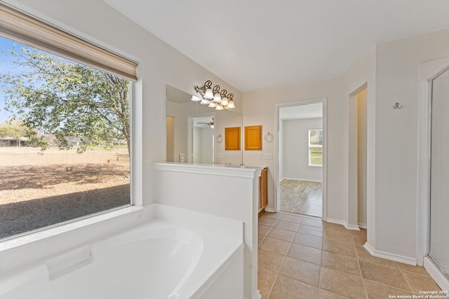 bathroom featuring tile patterned flooring, an enclosed shower, and a bath