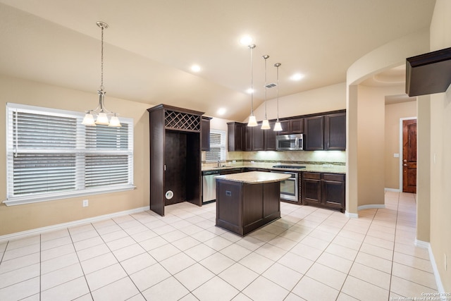 kitchen with stainless steel appliances, decorative backsplash, light tile patterned flooring, vaulted ceiling, and dark brown cabinetry