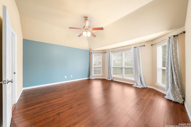 spare room featuring lofted ceiling, ceiling fan, baseboards, and wood finished floors