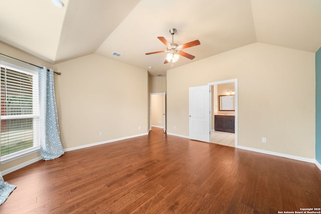 unfurnished bedroom with lofted ceiling, visible vents, ceiling fan, wood finished floors, and baseboards