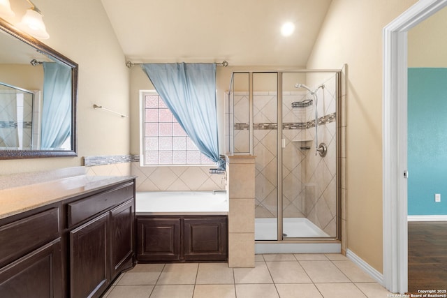 bathroom with lofted ceiling, a garden tub, a shower stall, and tile patterned flooring