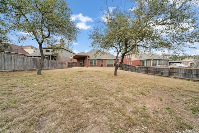 view of yard with a fenced backyard