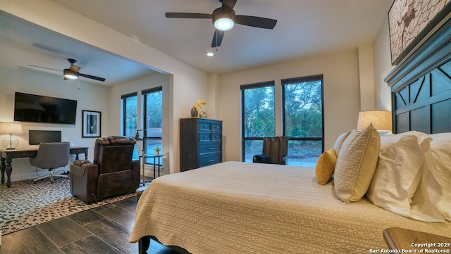 bedroom with a ceiling fan and wood finish floors