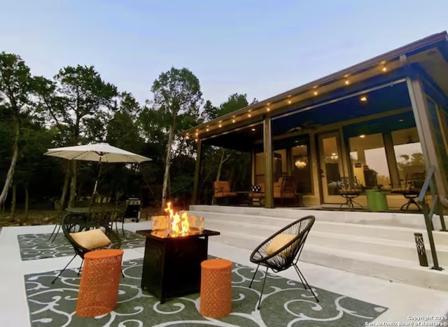 view of patio / terrace with a fire pit