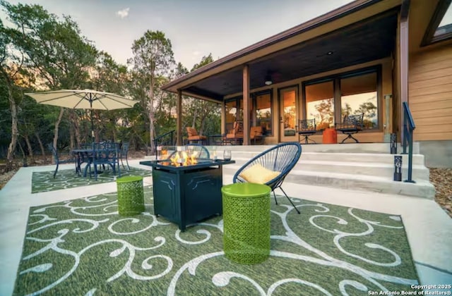 view of patio / terrace featuring an outdoor fire pit