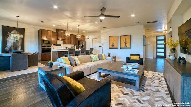 living area featuring recessed lighting, wood finished floors, visible vents, baseboards, and a ceiling fan