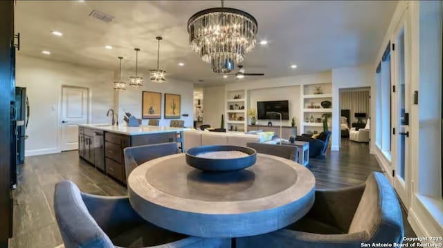 dining space with visible vents, dark wood-type flooring, built in shelves, a chandelier, and recessed lighting