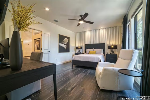 bedroom featuring dark wood-style floors, a ceiling fan, visible vents, and baseboards