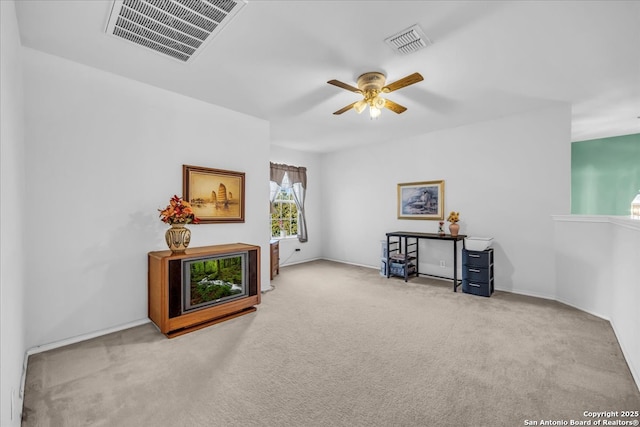 living area with carpet, visible vents, and ceiling fan