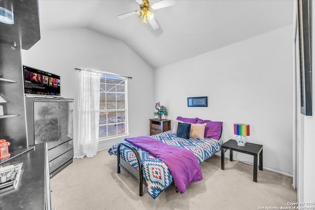 carpeted bedroom with vaulted ceiling and ceiling fan