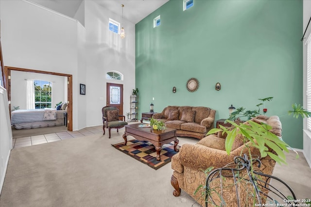 tiled living room with carpet floors and a high ceiling