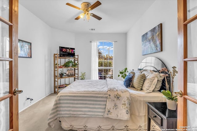 bedroom featuring light carpet, ceiling fan, french doors, and visible vents