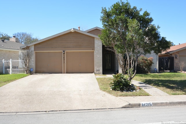 view of front of property featuring brick siding, concrete driveway, an attached garage, fence, and a front lawn