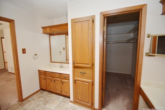 bathroom with vanity and baseboards