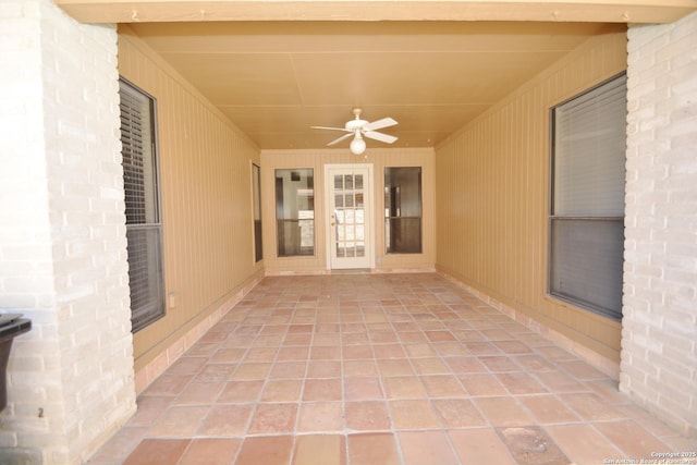 interior space with ceiling fan