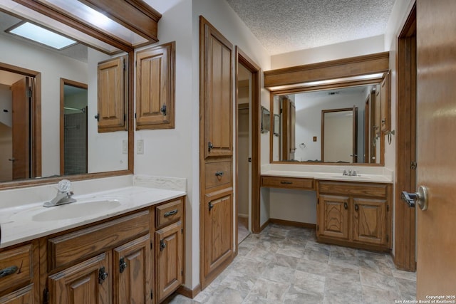 14215 Indian Woods, San Antonio, TX 78249 - full bath featuring a textured ceiling, two vanities, and a sink