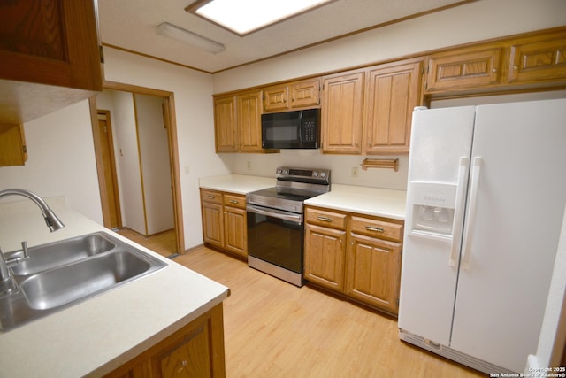 kitchen with black microwave, a sink, light wood-style floors, stainless steel electric stove, and white fridge with ice dispenser