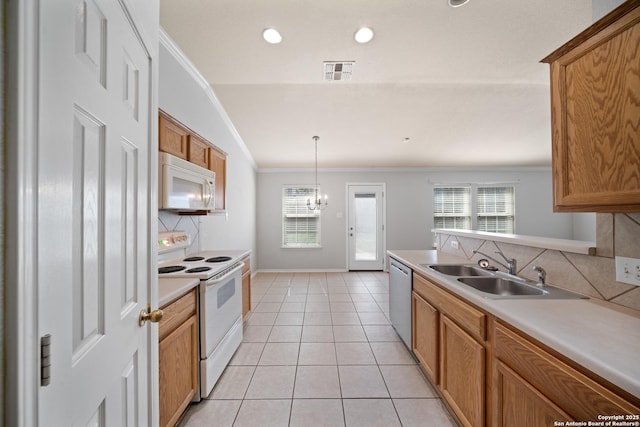 kitchen with light tile patterned flooring, white appliances, a sink, visible vents, and crown molding