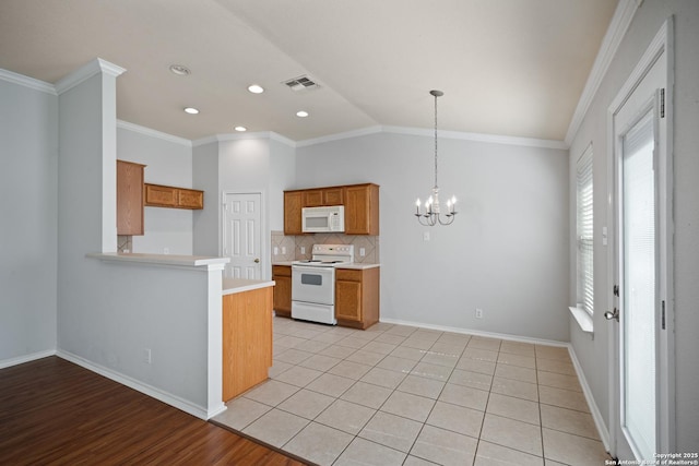 kitchen with light countertops, white appliances, brown cabinets, and visible vents