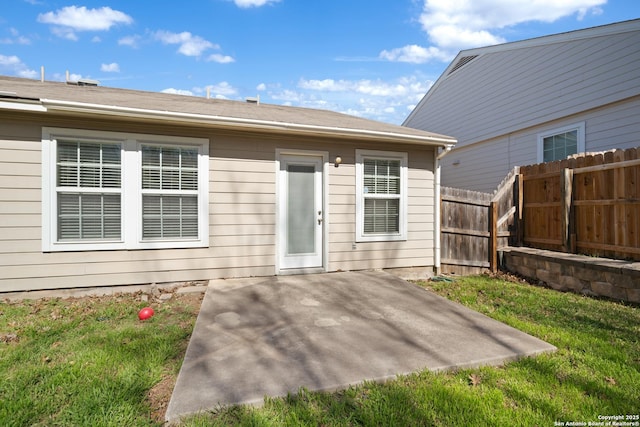 back of house with a yard, fence, and a patio