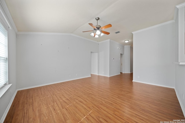 empty room featuring baseboards, lofted ceiling, ceiling fan, crown molding, and light wood-type flooring