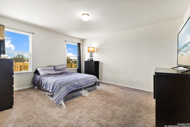 bedroom featuring carpet flooring and baseboards