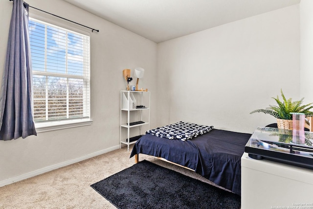 carpeted bedroom featuring baseboards