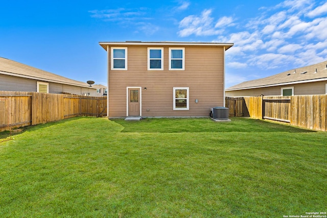 rear view of property featuring a fenced backyard, central AC unit, and a lawn