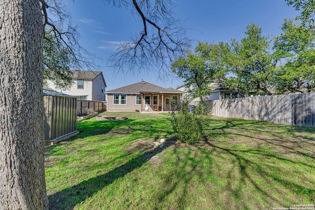 exterior space with a fenced backyard and a lawn