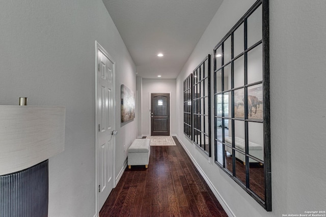 interior space featuring baseboards and wood finished floors