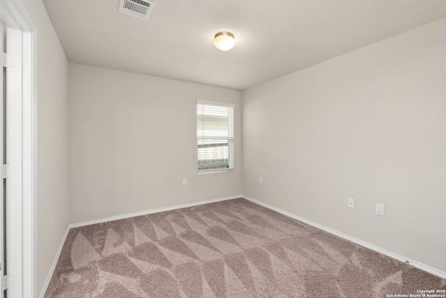 unfurnished room featuring carpet, visible vents, and baseboards