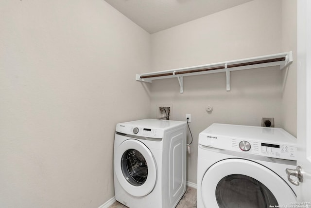 laundry area featuring laundry area, separate washer and dryer, and baseboards