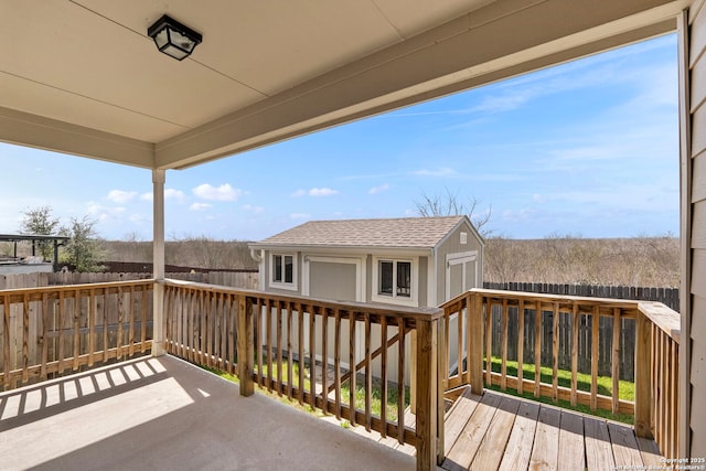 wooden deck with fence and an outbuilding