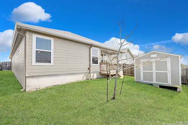 exterior space with a yard, an outdoor structure, a storage shed, and central AC unit